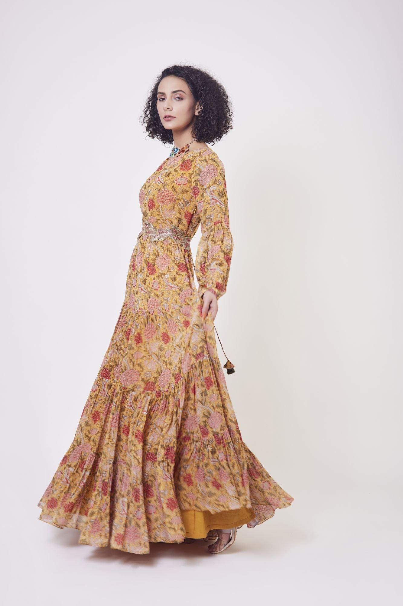 Buy stunning yellow floral print georgette tiered gown in USA. Dazzle on weddings and special occasions with exquisite Indian designer dresses, sharara suits, Anarkali suits, wedding lehengas from Pure Elegance Indian fashion store in USA.-left