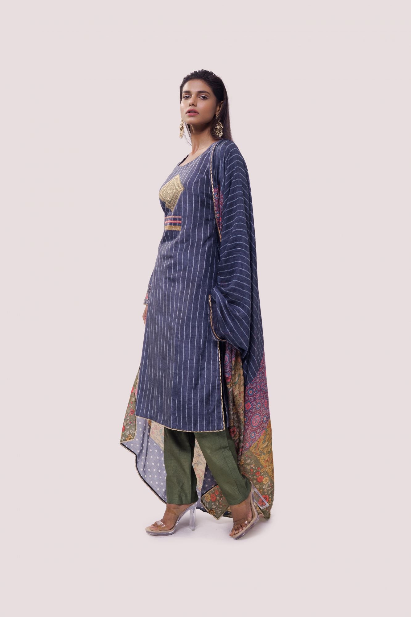 Shop blue striped chanderi suit in USA with green pants. Dazzle on weddings and special occasions with exquisite Indian designer dresses, sharara suits, Anarkali suits, wedding lehengas from Pure Elegance Indian fashion store in USA.-left