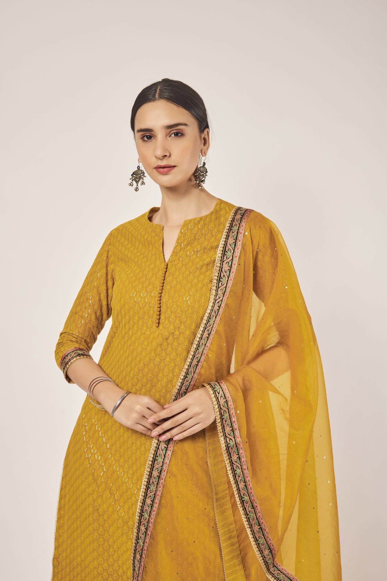 Shop beautiful mustard tikki and aari work georgette suit online in USA with dupatta. Dazzle on weddings and special occasions with exquisite Indian designer dresses, sharara suits, Anarkali suits, wedding lehengas from Pure Elegance Indian fashion store in USA.-closeup
