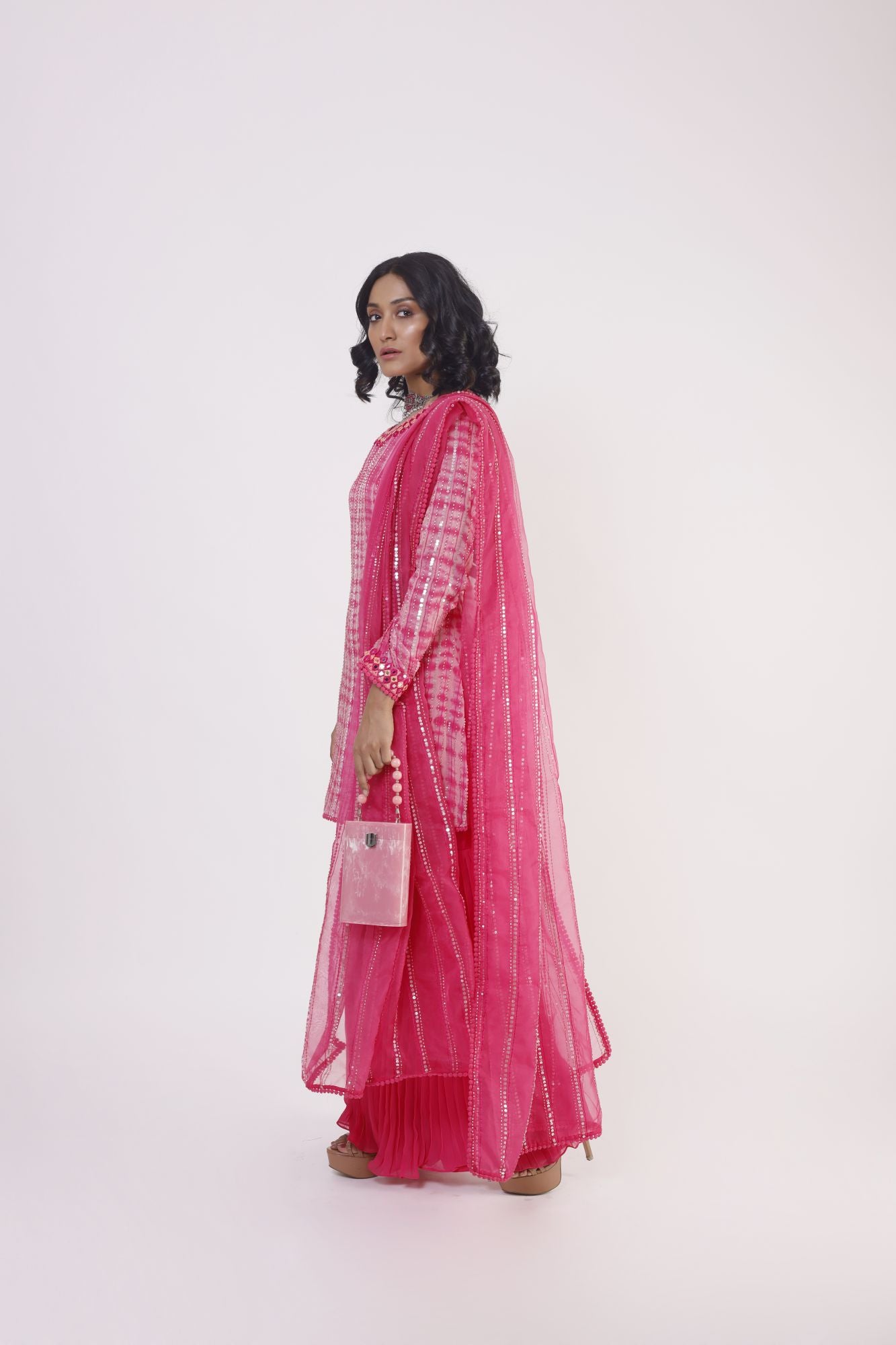 Buy pink mirror work georgette sharara suit online in USA with dupatta. Dazzle on weddings and special occasions with exquisite Indian designer dresses, sharara suits, Anarkali suits, wedding lehengas from Pure Elegance Indian fashion store in USA.-side