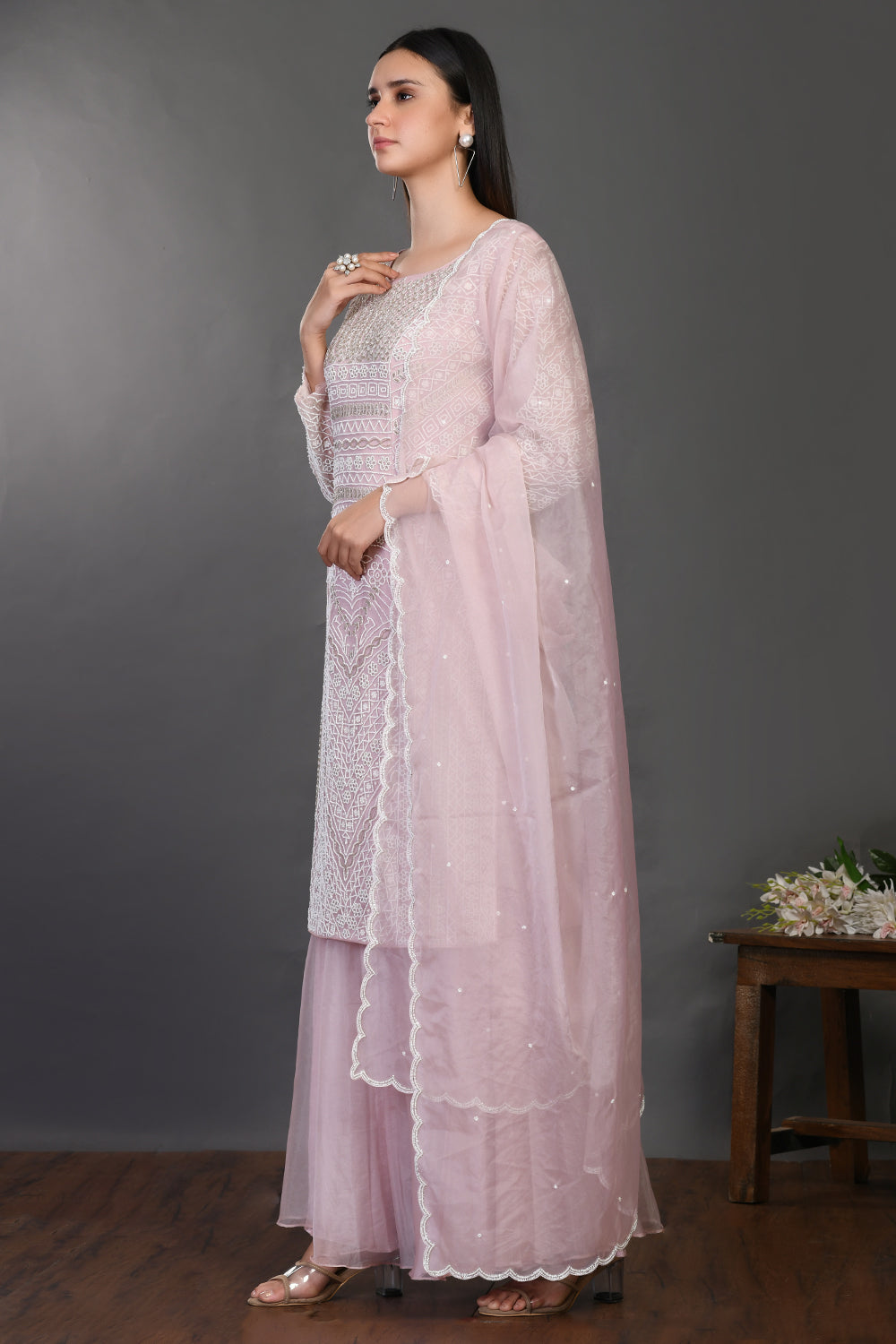 Shop powder pink embroidered organza sharara suit online in USA with dupatta. Dazzle on weddings and special occasions with exquisite Indian designer dresses, sharara suits, Anarkali suits, wedding lehengas from Pure Elegance Indian fashion store in USA.-left