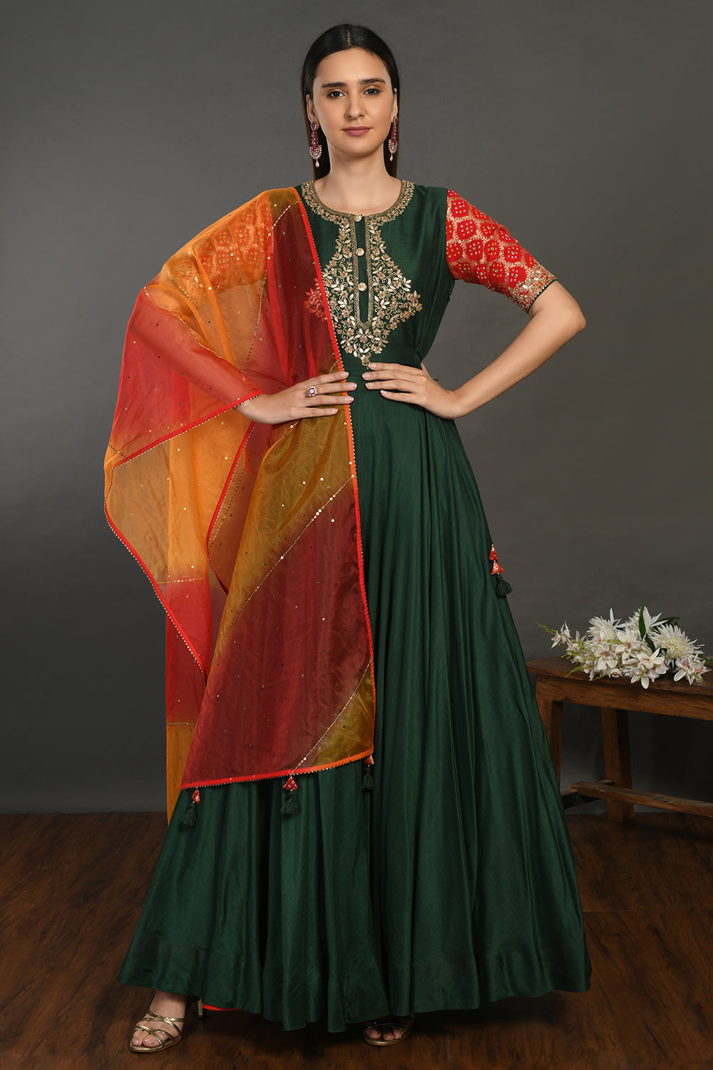 Buy beautiful bottle green muslin Anarkali suit online in USA with red orange dupatta. Dazzle on weddings and special occasions with exquisite Indian designer dresses, sharara suits, Anarkali suits, wedding lehengas from Pure Elegance Indian fashion store in USA.-full view