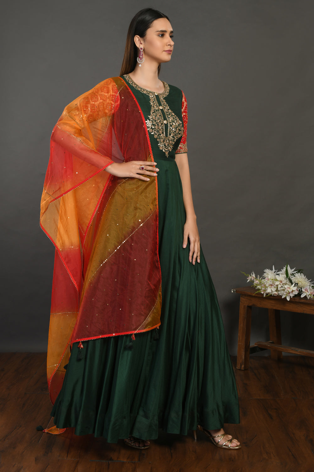 Buy beautiful bottle green muslin Anarkali suit online in USA with red orange dupatta. Dazzle on weddings and special occasions with exquisite Indian designer dresses, sharara suits, Anarkali suits, wedding lehengas from Pure Elegance Indian fashion store in USA.-right