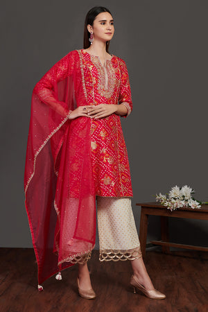 Buy red and white stone work bandhej palazzo suit online in USA with dupatta. Dazzle on weddings and special occasions with exquisite Indian designer dresses, sharara suits, Anarkali suits, wedding lehengas from Pure Elegance Indian fashion store in USA.-front