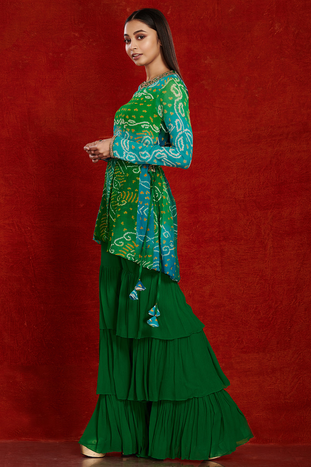 Shop green bandhej georgette sharara suit online in USA with sequin belt. Dazzle on weddings and special occasions with exquisite Indian designer dresses, sharara suits, Anarkali suits, wedding lehengas from Pure Elegance Indian fashion store in USA.-side
