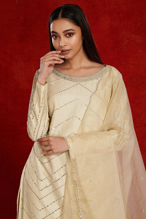 Shop stunning cream embroidered silk suit online in USA with pants. Dazzle on weddings and special occasions with exquisite Indian designer dresses, sharara suits, Anarkali suits, wedding lehengas from Pure Elegance Indian fashion store in USA.-closeup