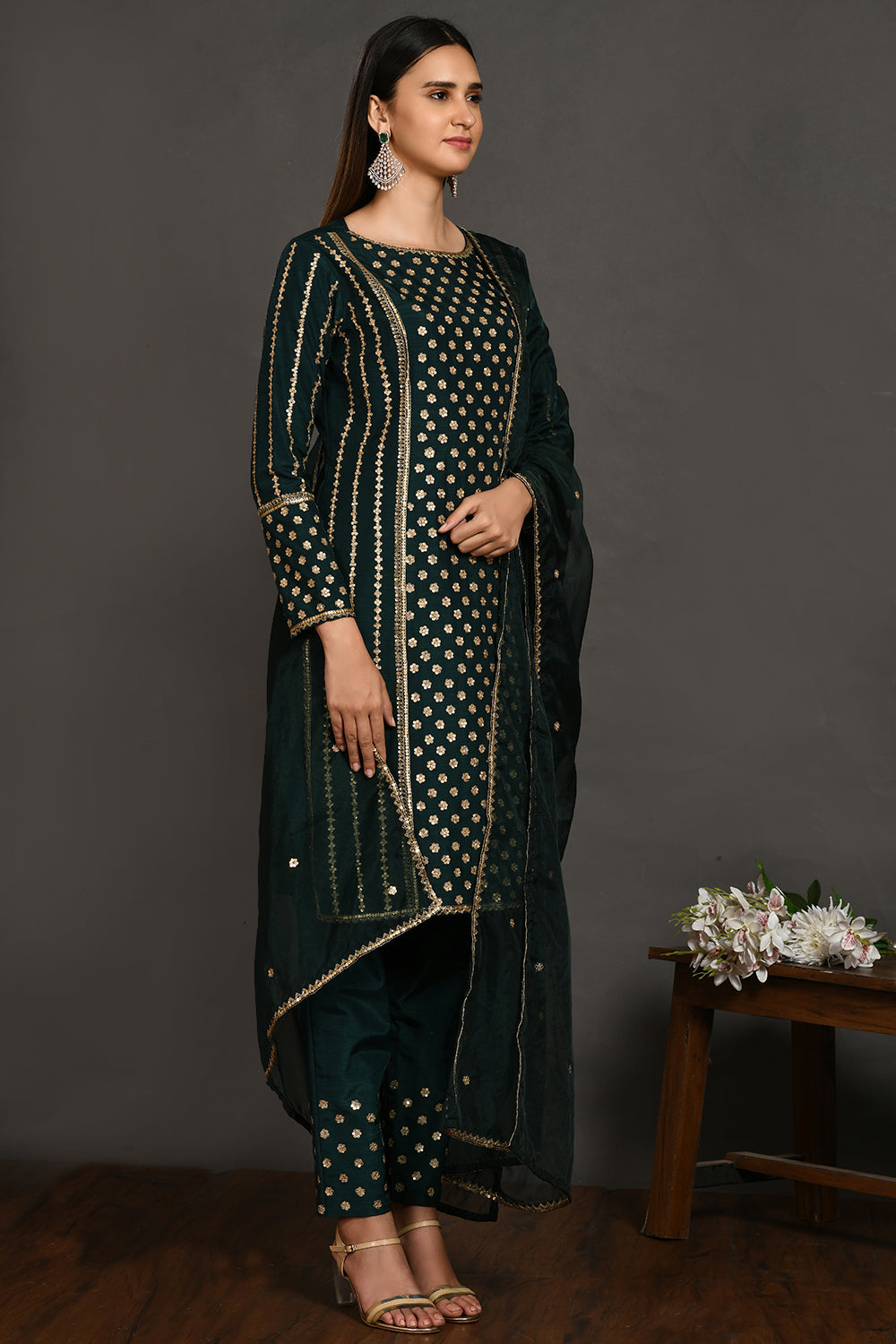 Shop stunning bottle green cutdana, sequin and zari work silk suit online in USA. Dazzle on weddings and special occasions with exquisite Indian designer dresses, sharara suits, Anarkali suits, wedding lehengas from Pure Elegance Indian fashion store in USA.-right