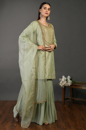 Buy sage green embroidered Mysore silk sharara suit online in USA with dupatta. Dazzle on weddings and special occasions with exquisite Indian designer dresses, sharara suits, Anarkali suits, wedding lehengas from Pure Elegance Indian fashion store in USA.-right