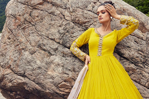 Buy a Beautiful yellow embroidered georgette anarkali suit with a pink dupatta. Shop online from Pure Elegance. Dazzle on weddings and special occasions with exquisite Indian designer dresses, sharara suits, Anarkali suits, and wedding lehengas from Pure Elegance Indian fashion store in the USA.