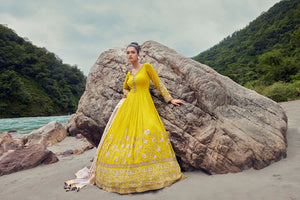 Buy a Beautiful yellow embroidered georgette anarkali suit with a pink dupatta. Shop online from Pure Elegance. Dazzle on weddings and special occasions with exquisite Indian designer dresses, sharara suits, Anarkali suits, and wedding lehengas from Pure Elegance Indian fashion store in the USA.