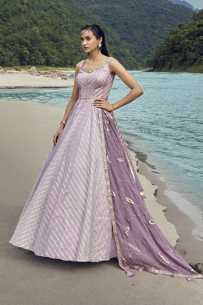 Buy a Beautiful purple self-embroidered silk Anarkali suit with a dupatta. Shop online from Pure Elegance. Dazzle on weddings and special occasions with exquisite Indian designer dresses, sharara suits, Anarkali suits, and wedding lehengas from Pure Elegance Indian fashion store in the USA.