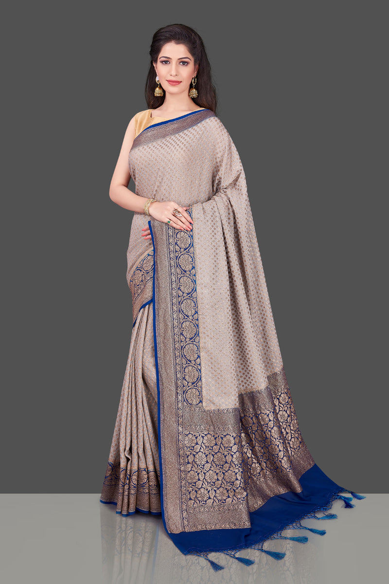Buy light grey georgette Benarasi sari online in USA with blue zari border. Shop beautiful Banarasi sarees, georgette sarees, pure muga silk sarees in USA from Pure Elegance Indian fashion boutique in USA. Get spoiled for choices with a splendid variety of Indian saris to choose from! Shop now.-full view