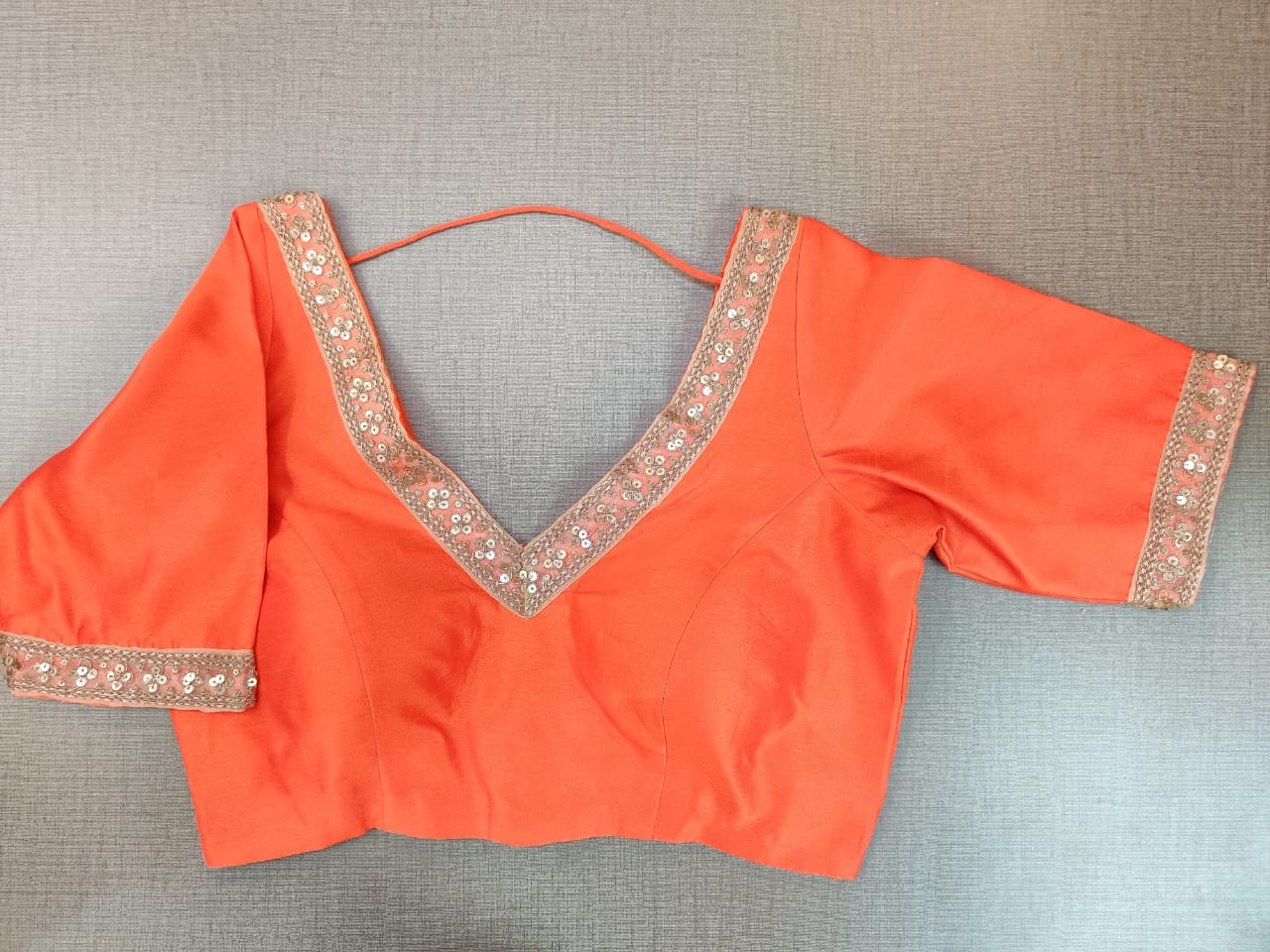 Shop stunning bright orange embroidered sari blouse online in USA. Elevate your Indian ethnic saree looks with beautiful readymade saree blouse, embroidered saree blouses, Banarasi saree blouse, designer sari blouses from Pure Elegance Indian fashion store in USA.-front