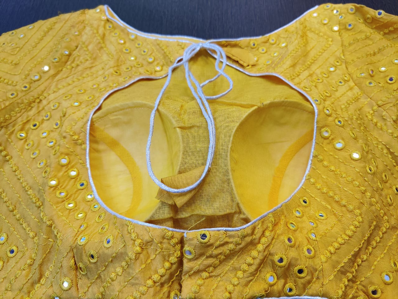 Buy gorgeous yellow readymade saree blouse online in USA with mirror embroidery. Elevate your ethnic sari style with a stunning collection of designer sari blouses, embroidered saree blouses, Banarasi sari blouse, fancy sari blouse from Pure Elegance Indian clothing store in USA.-back