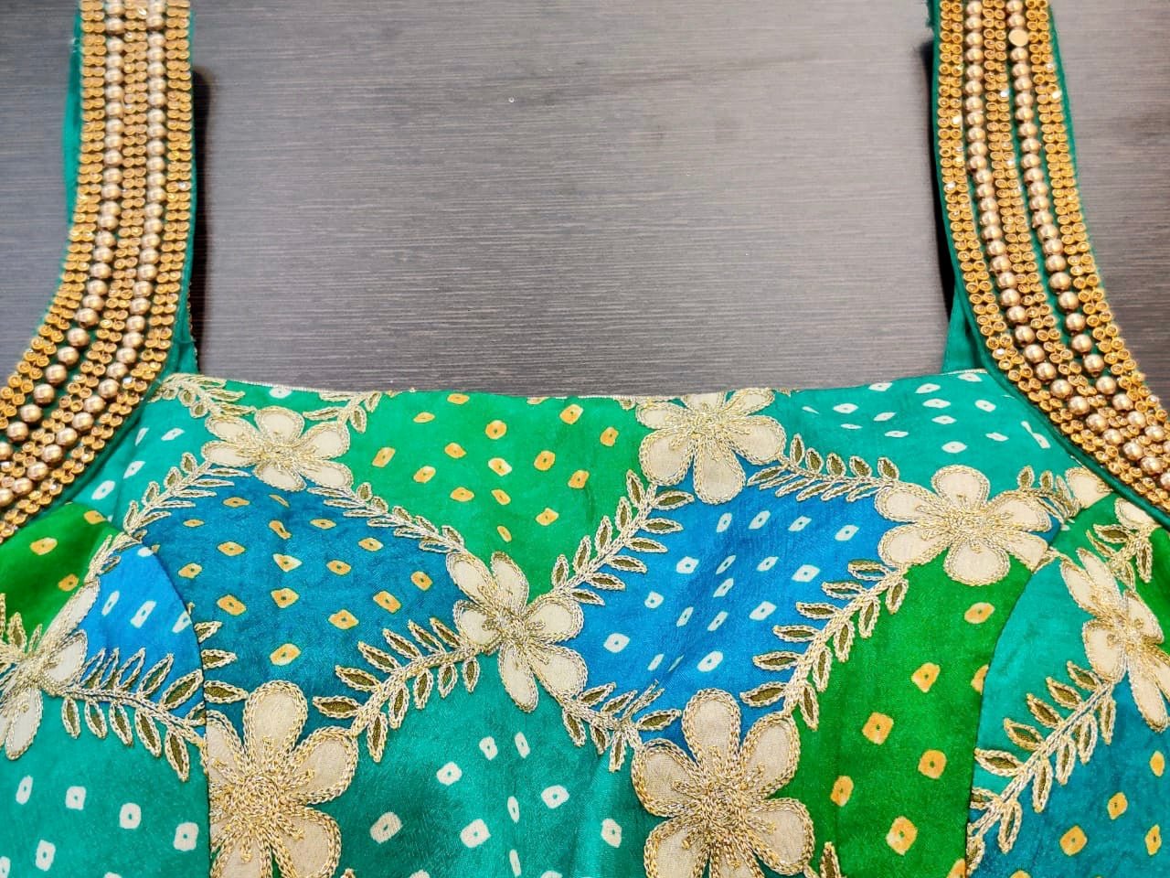 Buy stunning green and blue embroidered Bandhej sari blouse online in USA. Elevate your ethnic sari style with a stunning collection of designer saree blouses, embroidered saree blouses, Banarasi sari blouse, silk sari blouse from Pure Elegance Indian clothing store in USA.-neck