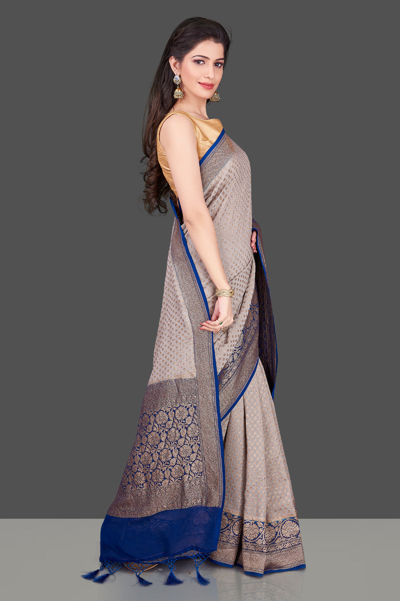 Buy light grey georgette Benarasi sari online in USA with blue zari border. Shop beautiful Banarasi sarees, georgette sarees, pure muga silk sarees in USA from Pure Elegance Indian fashion boutique in USA. Get spoiled for choices with a splendid variety of Indian saris to choose from! Shop now.-side