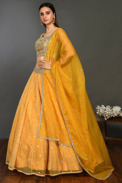 Buy stunning yellow organza lehenga online in USA with dupatta. Get festive ready in beautiful designer Anarkali suits, designer lehenga, wedding gowns, sharara suits, designer sarees from Pure Elegance Indian fashion store in USA.-side