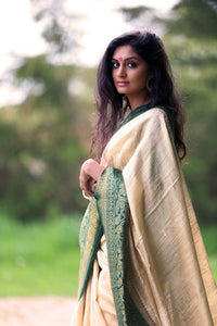 Shop beautiful off-white tussar Benarasi saree online in USA with green zari border. Set high fashion standard with your beautiful collection of Indian designer sarees from Pure Elegance. Pick your favorite pure silk saris, traditional Banarasi sarees, embroidered saris from our exclusive Indian clothing store in USA.-side view