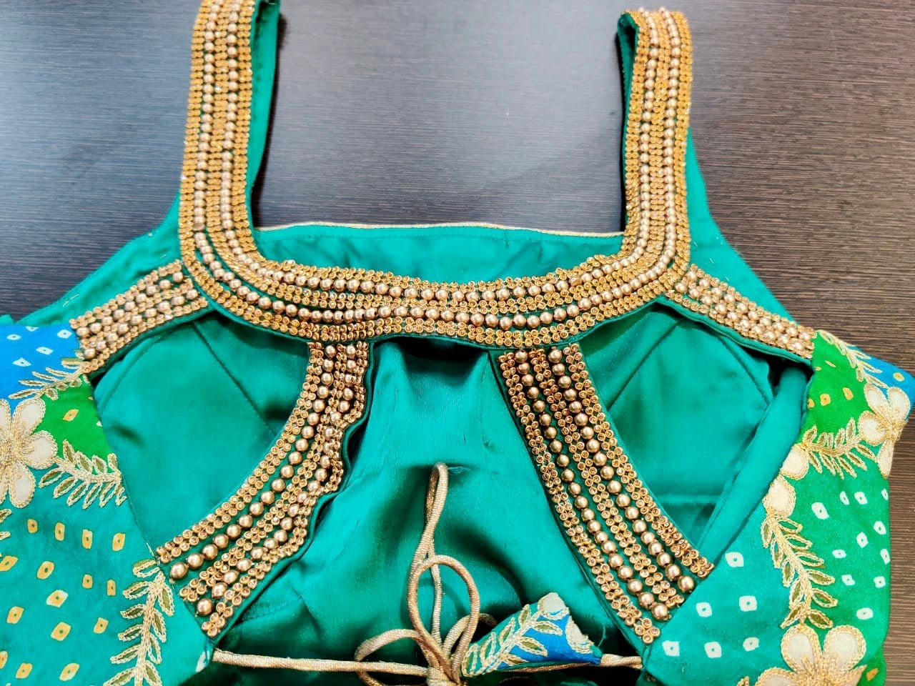 Buy stunning green and blue embroidered Bandhej sari blouse online in USA. Elevate your ethnic sari style with a stunning collection of designer saree blouses, embroidered saree blouses, Banarasi sari blouse, silk sari blouse from Pure Elegance Indian clothing store in USA.-back