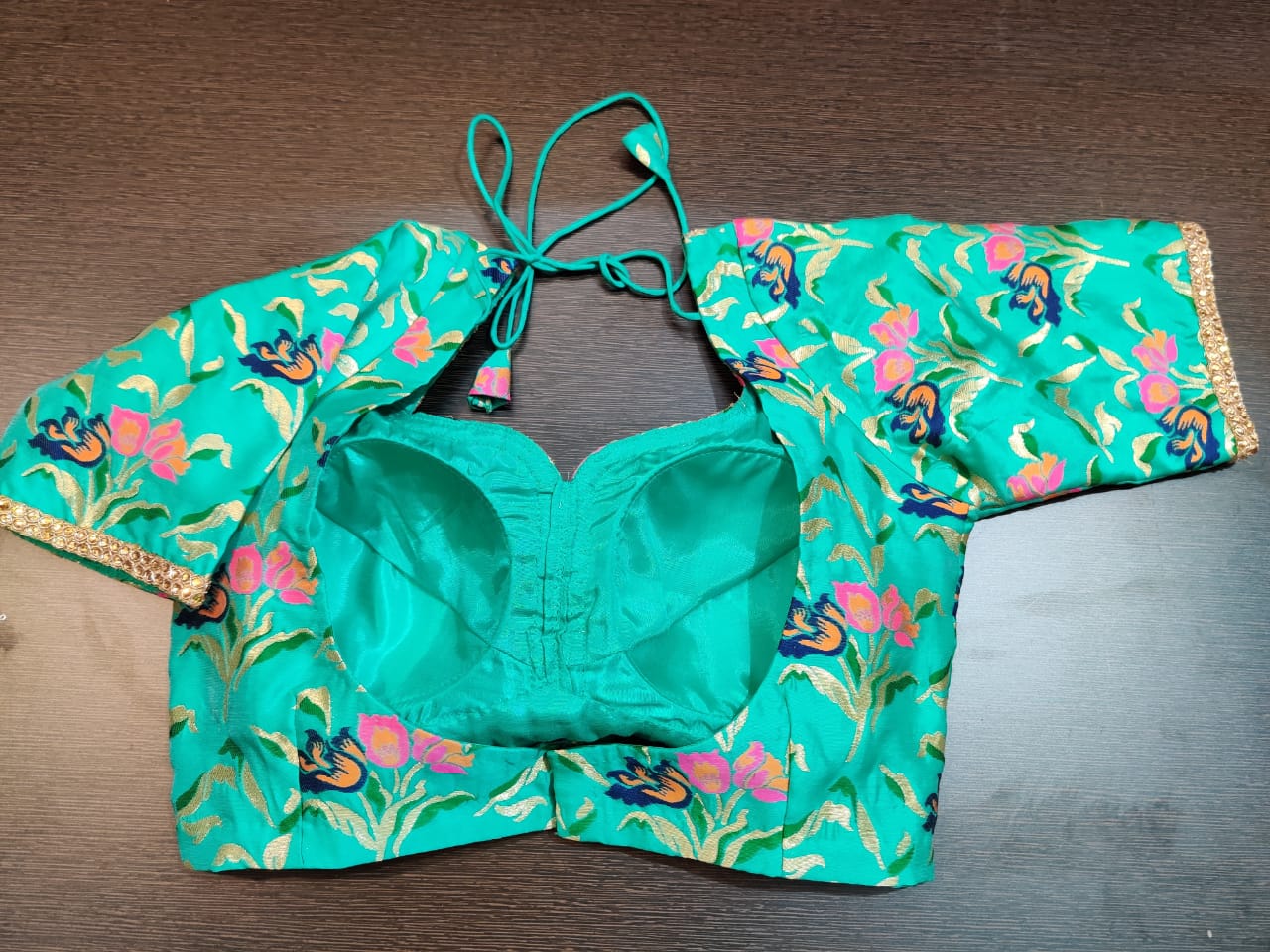 Buy stunning sea green floral saree blouse online in USA with golden lace. Elevate your ethnic saree style with a tasteful collection of designer saree blouses, embroidered saree blouses, Banarasi saree blouse, silk sari blouse from Pure Elegance Indian clothing store in USA.-back