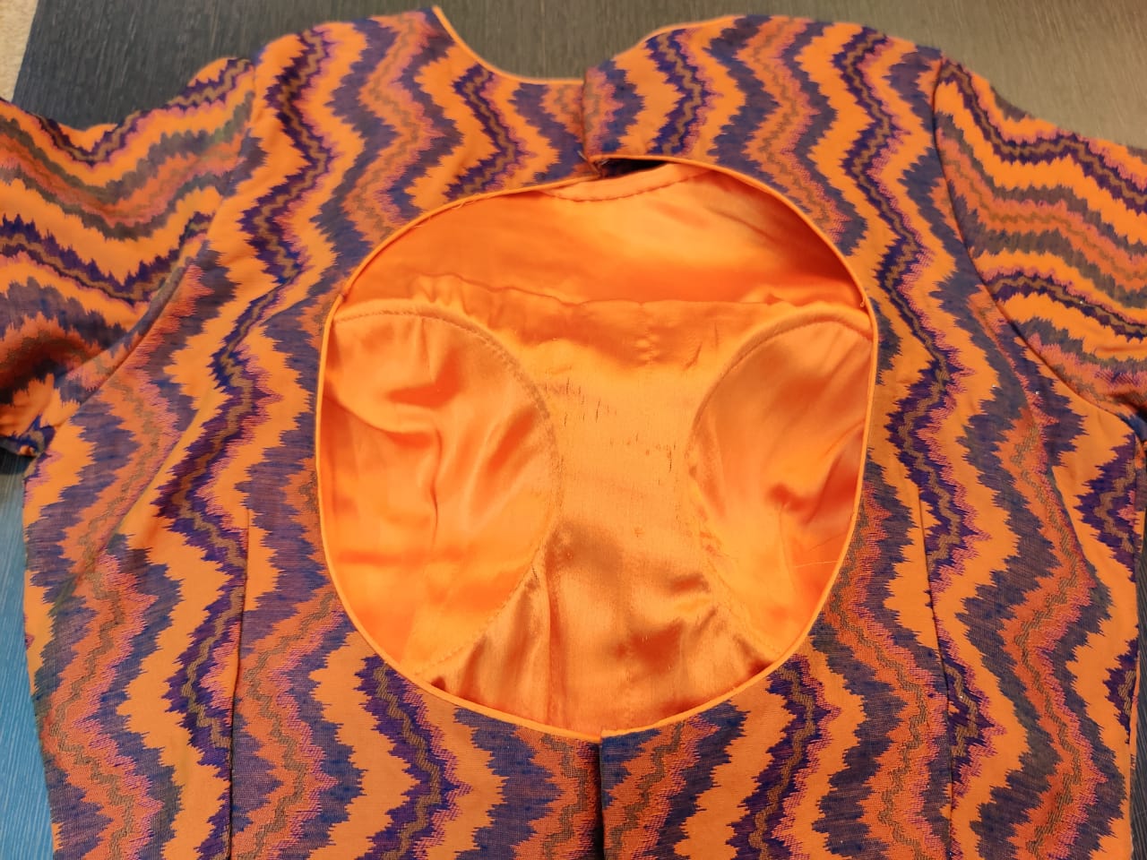 Buy gorgeous orange purple designer embroidered saree blouse online in USA. Elevate your ethnic sari style with a stunning collection of designer sari blouses, embroidered saree blouses, Banarasi sari blouse, fancy sari blouse from Pure Elegance Indian clothing store in USA.-back