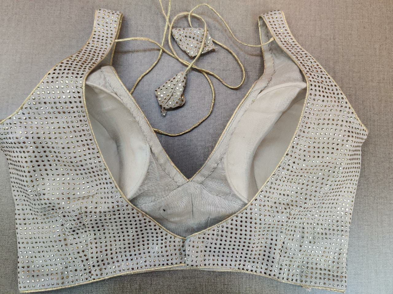 Buy stunning grey stone work sleeveless sari blouse online in USA. Elevate your Indian ethnic sari looks with exquisite readymade saree blouse, embroidered saree blouses, Banarasi sari blouse, designer saree blouse from Pure Elegance Indian clothing store in USA.-back
