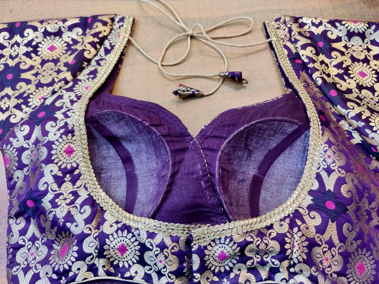 Shop gorgeous purple Banarsi silk saree blouse online in USA with golden lace. Elevate your ethnic saree style with a tasteful collection of designer saree blouses, embroidered sari blouses, Banarasi blouses, silk saree blouses from Pure Elegance Indian clothing store in USA.-back