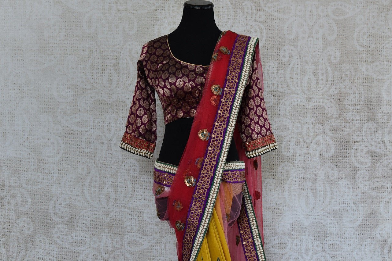 90A486 Traditional half net, half georgette saree from India with traditional motifs and embellishments, ideal for wedding functions. The shaded yellow and pink saree is available online at our ethnic clothing store in USA - Pure Elegance.