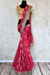 90a621 Traditional pink embroidered saree for sale online in USA. The jute Banarasi saree with golden leafy pattern comes with a beige, embroidered raw silk designer blouse. This saree makes for the perfect Indian outfit to wear at small wedding function. 