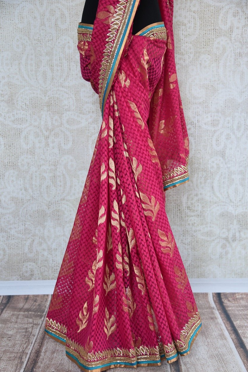 90a621 Traditional embroidered saree for sale online in USA. The jute pink Banarasi saree with golden leafy pattern on the body comes with a beige, embroidered raw silk designer blouse. This saree makes for the perfect Indian outfit to wear at small wedding function. 
