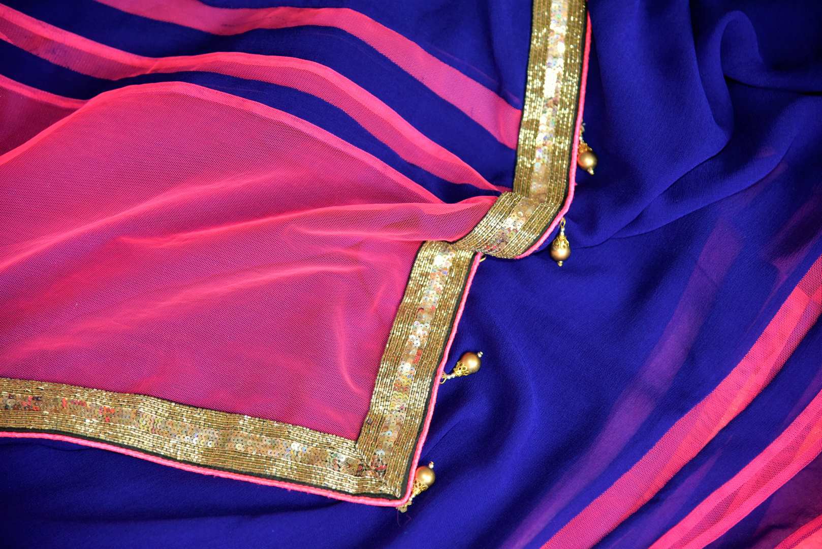 Buy dark blue georgette saree online in USA with pink embroidered net border from Pure Elegance. Let your ethnic style be one of a kind with an exquisite variety of Indian handloom sarees, pure silk sarees, designer sarees from our exclusive fashion store in USA.-details
