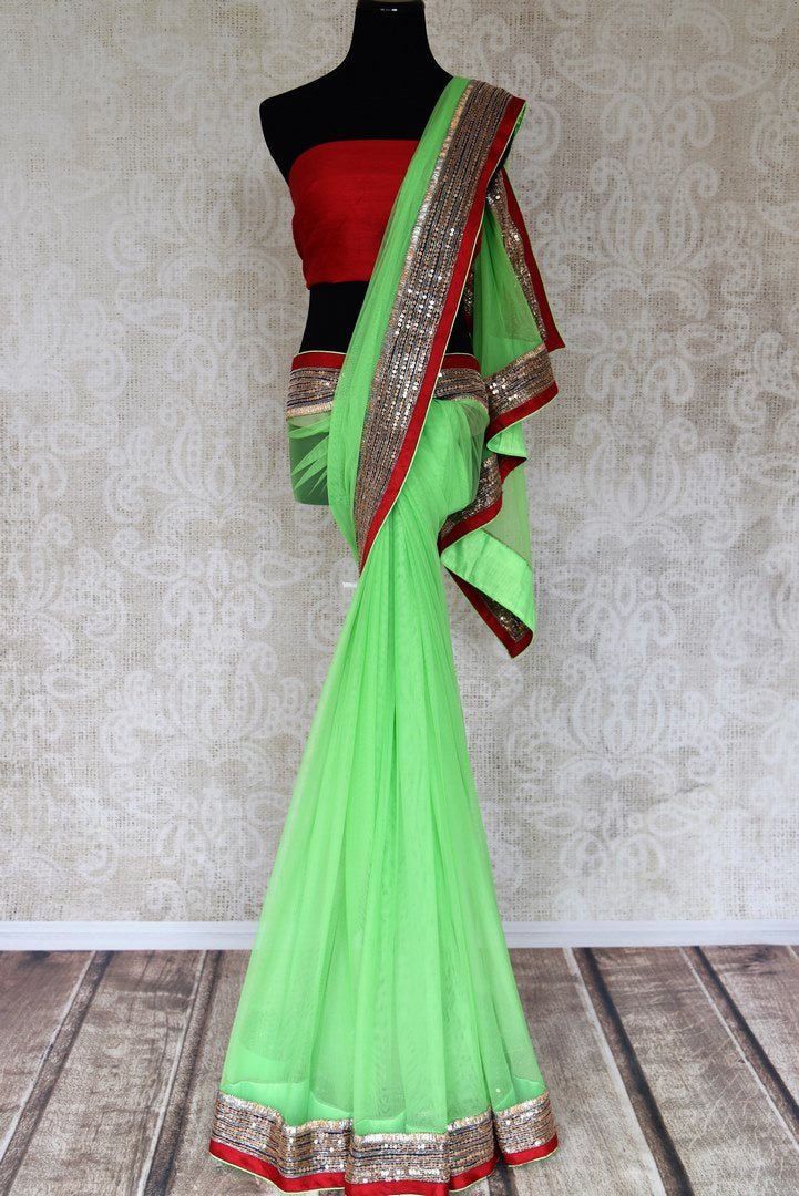 Shop parrot green net saree online in USA with embroidered border from Pure Elegance. Let your ethnic style be one of a kind with an exquisite variety of Indian handloom sarees, pure silk sarees, Bollywood sarees from our exclusive fashion store in USA.-full view
