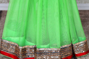 Shop parrot green net saree online in USA with embroidered border from Pure Elegance. Let your ethnic style be one of a kind with an exquisite variety of Indian handloom sarees, pure silk sarees, Bollywood sarees from our exclusive fashion store in USA.-pleats