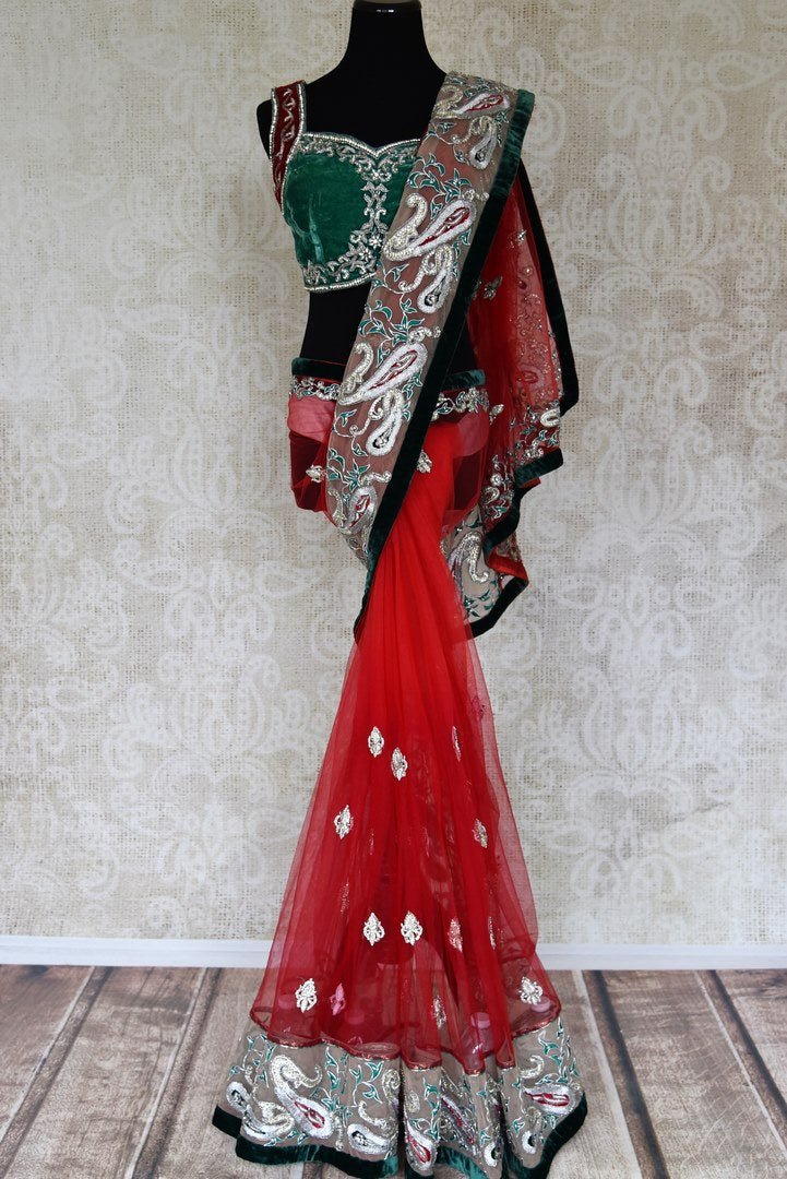 Buy red net saree online in USA with green embroidered border and saree blouse from Pure Elegance. Let your ethnic style be one of a kind with an exquisite variety of Indian designer sarees, pure silk sarees, Bollywood sarees from our exclusive fashion store in USA.-full view