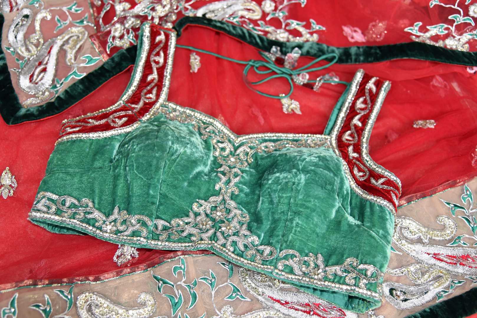 Buy red net saree online in USA with green embroidered border and saree blouse from Pure Elegance. Let your ethnic style be one of a kind with an exquisite variety of Indian designer sarees, pure silk sarees, Bollywood sarees from our exclusive fashion store in USA.-details