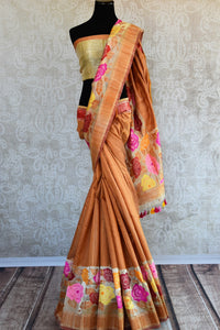 Tussar banarasi saree in orange yellow color with floral arrangement through the border and on pallu available in store Pure Elegance. Ideal pick for Parties.-Full view