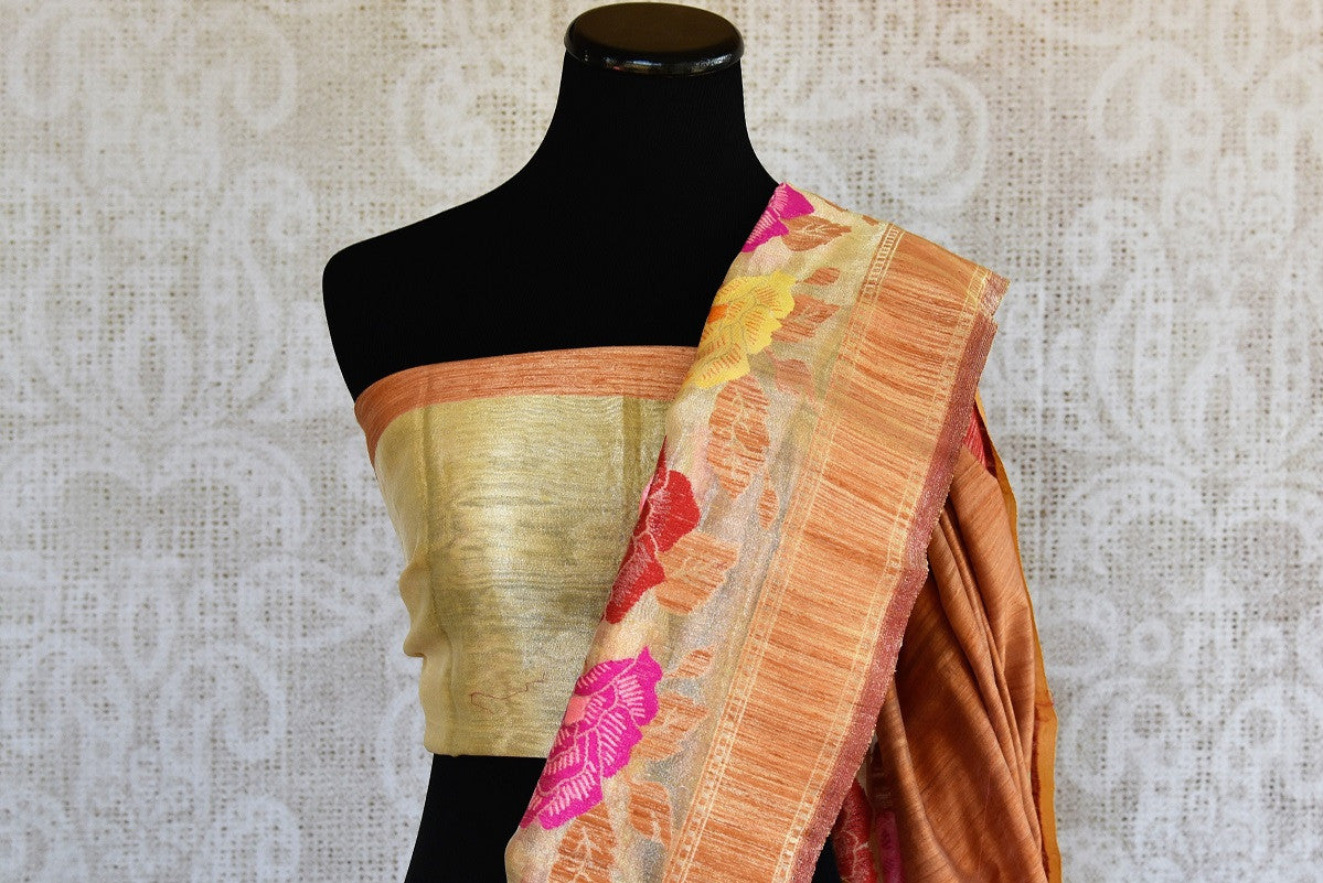 Tussar banarasi saree in orange yellow color with floral arrangement through the border and on pallu available in store Pure Elegance. Ideal pick for Parties.-pallu