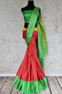 It's a red kanchivaram sari with checks in bottom with green blouse and border. It also has yellow border. Perfect traditional sari for party, festive occasion - front view