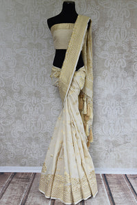 Classic and elegant off white hand woven muga banarasi saree. Perfect for festivals and pujas.-full view