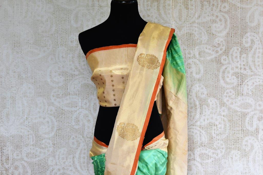 Buy green striped Banarasi silk saree online with gold tissue border. Pure Elegance store presents exquisite range of designer Indian sarees online for women in USA.-pallu