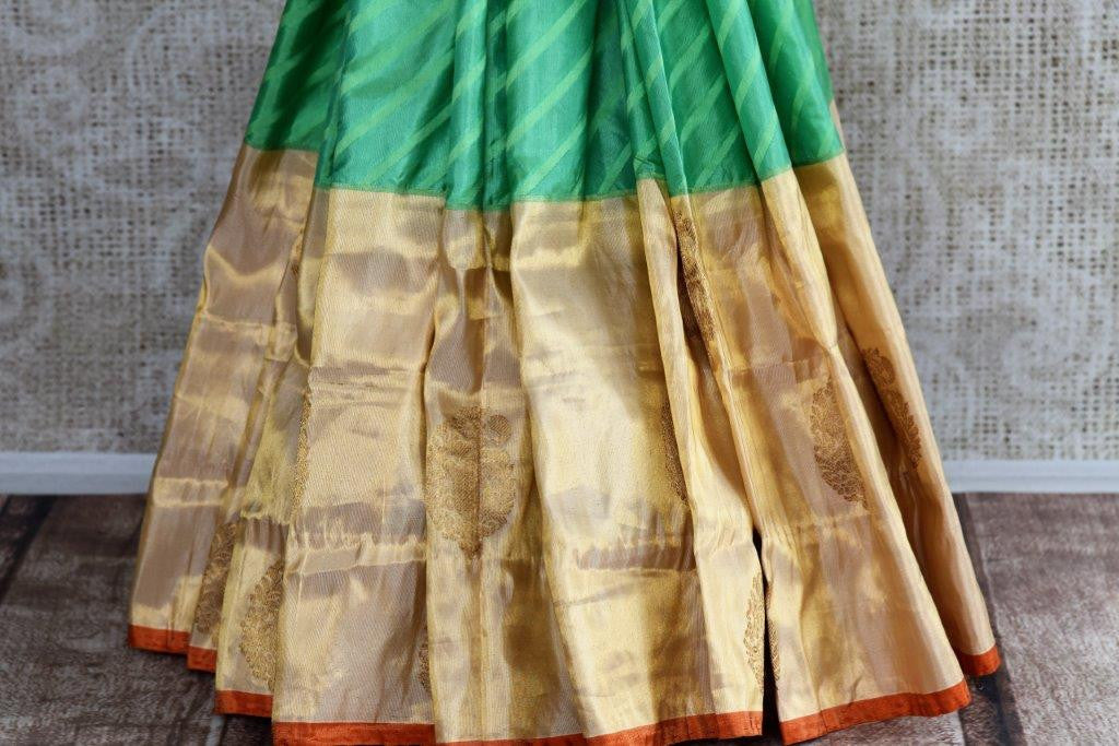 Buy green striped Banarasi silk saree online with gold tissue border. Pure Elegance store presents exquisite range of designer Indian sarees online for women in USA.-pleats