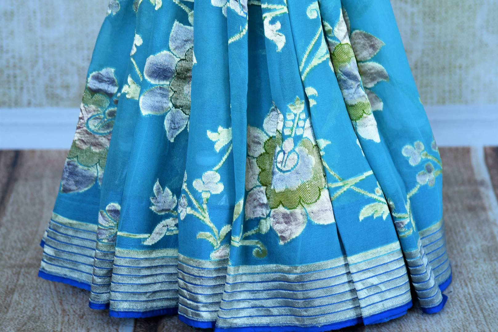 Buy turquoise blue georgette Banarasi saree online in USA. Pure Elegance store brings an exquisite range of Indian Banarasi georgette sarees in USA for women. Shop online.-pleats