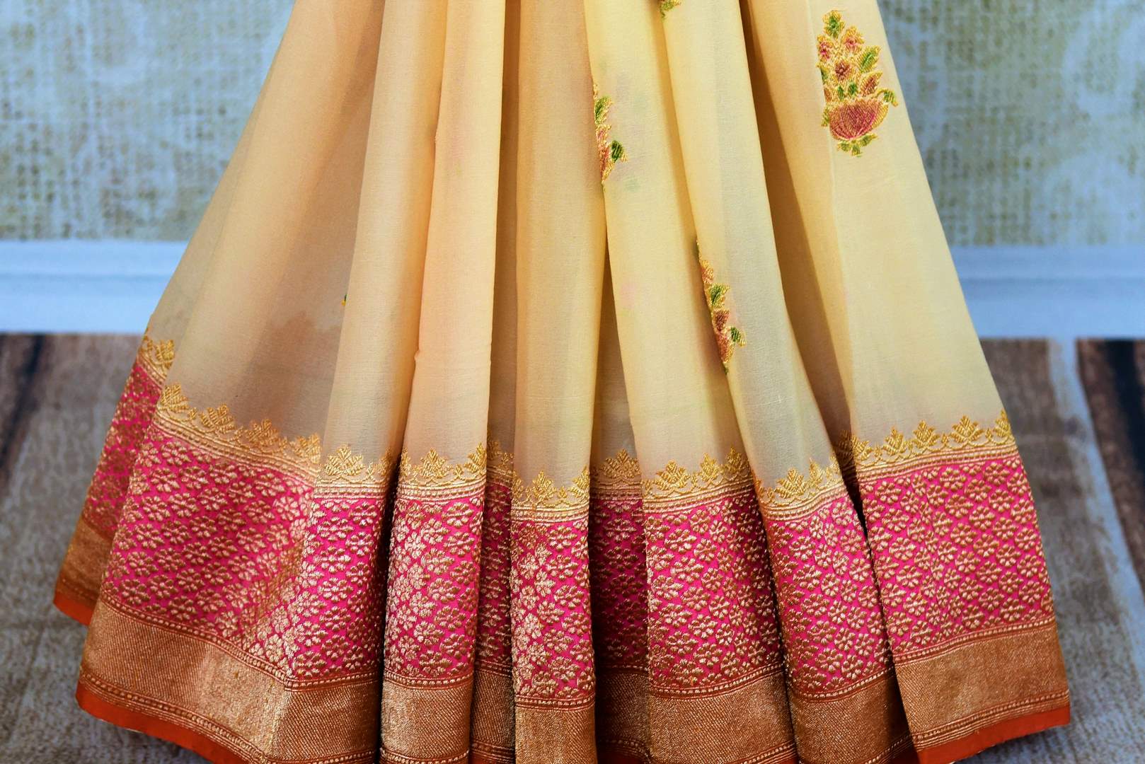 Buy cream georgette Banarasi sari with pink border online in USA. Pure Elegance store brings an exquisite range of Indian Banarasi sarees for online shopping in USA. -pleats