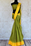 Buy green ikat khaddi sari online in USA with yellow border. Pure Elegance clothing store brings an alluring collection of ethnic Indian ikat saris in USA for women. -full view