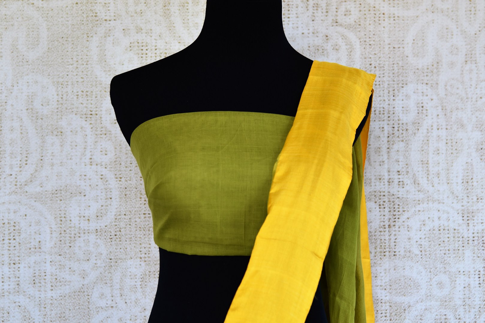 Buy green ikat khaddi sari online in USA with yellow border. Pure Elegance clothing store brings an alluring collection of ethnic Indian ikat saris in USA for women. -blouse pallu