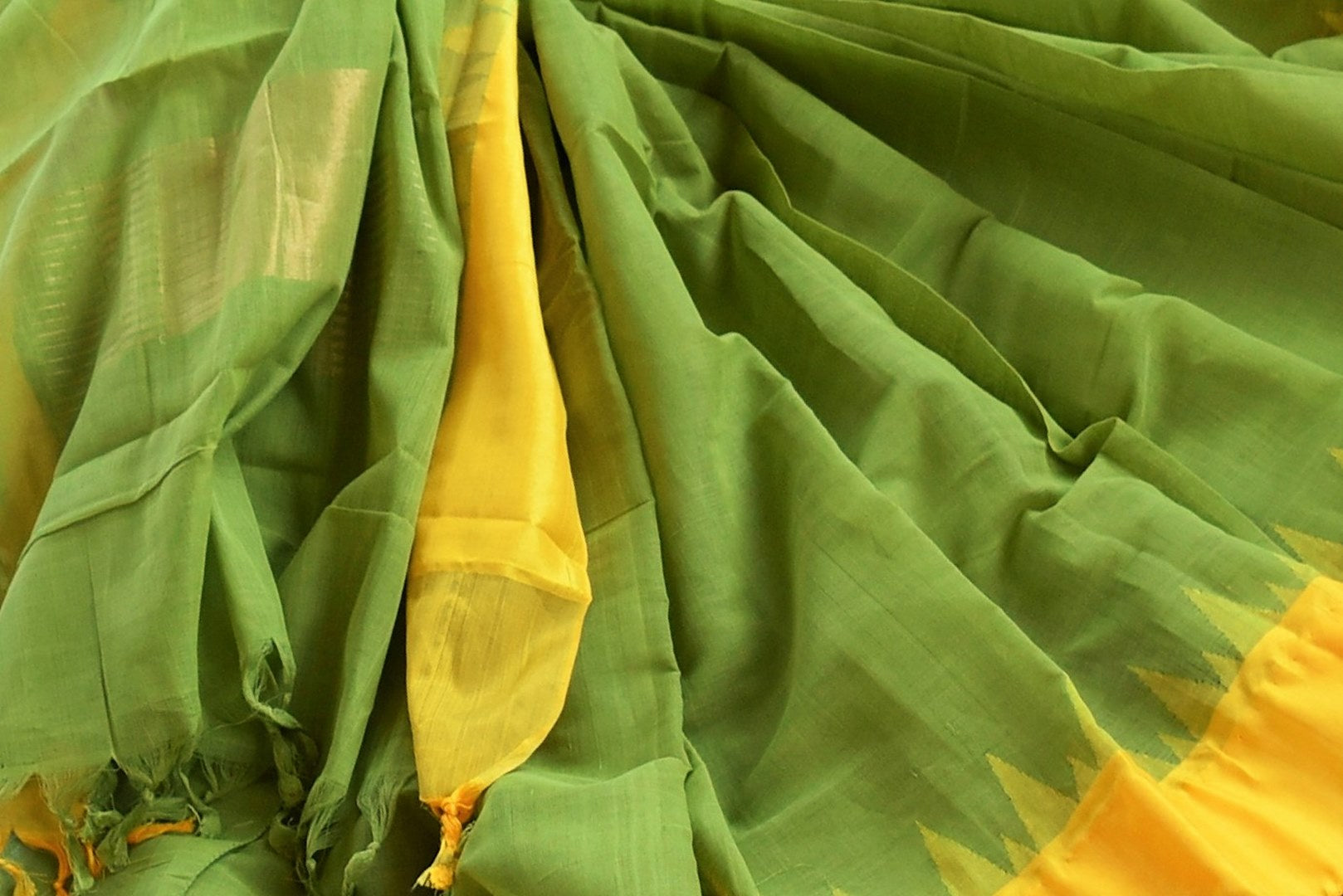 Buy green ikat khaddi sari online in USA with yellow border. Pure Elegance clothing store brings an alluring collection of ethnic Indian ikat saris in USA for women. -details