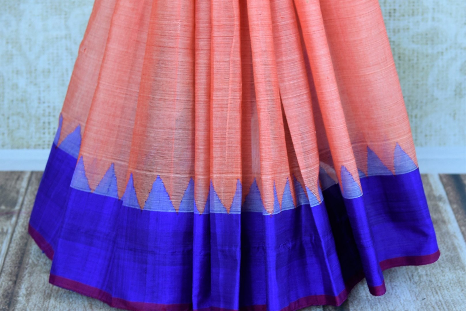Buy pink ikat khaddi sari online in USA with blue border. Pure Elegance clothing store brings an alluring collection of ethnic Indian ikkat saris in USA for women. -pleats
