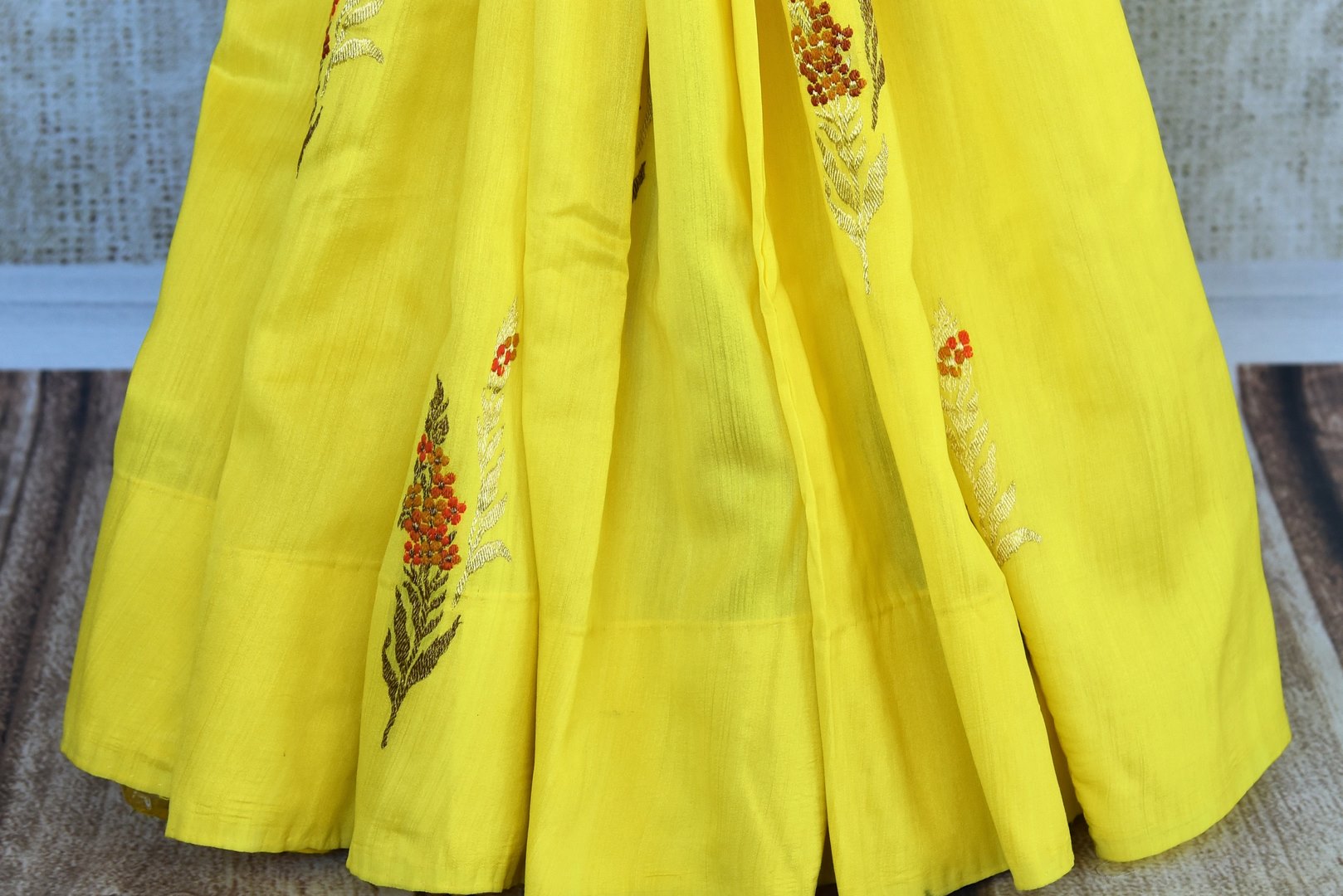 Buy bright yellow muga Banarasi saree online in USA. Pure Elegance clothing store brings an exclusive range of traditional Indian Benarasi sarees in USA for women.-pleats