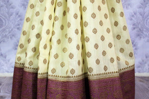 Lemon yellow Muga Banarasi saree with buta for online shopping in USA. Pure Elegance fashion store brings an alluring range of exquisite Indian handloom saris in USA for women. -pleats