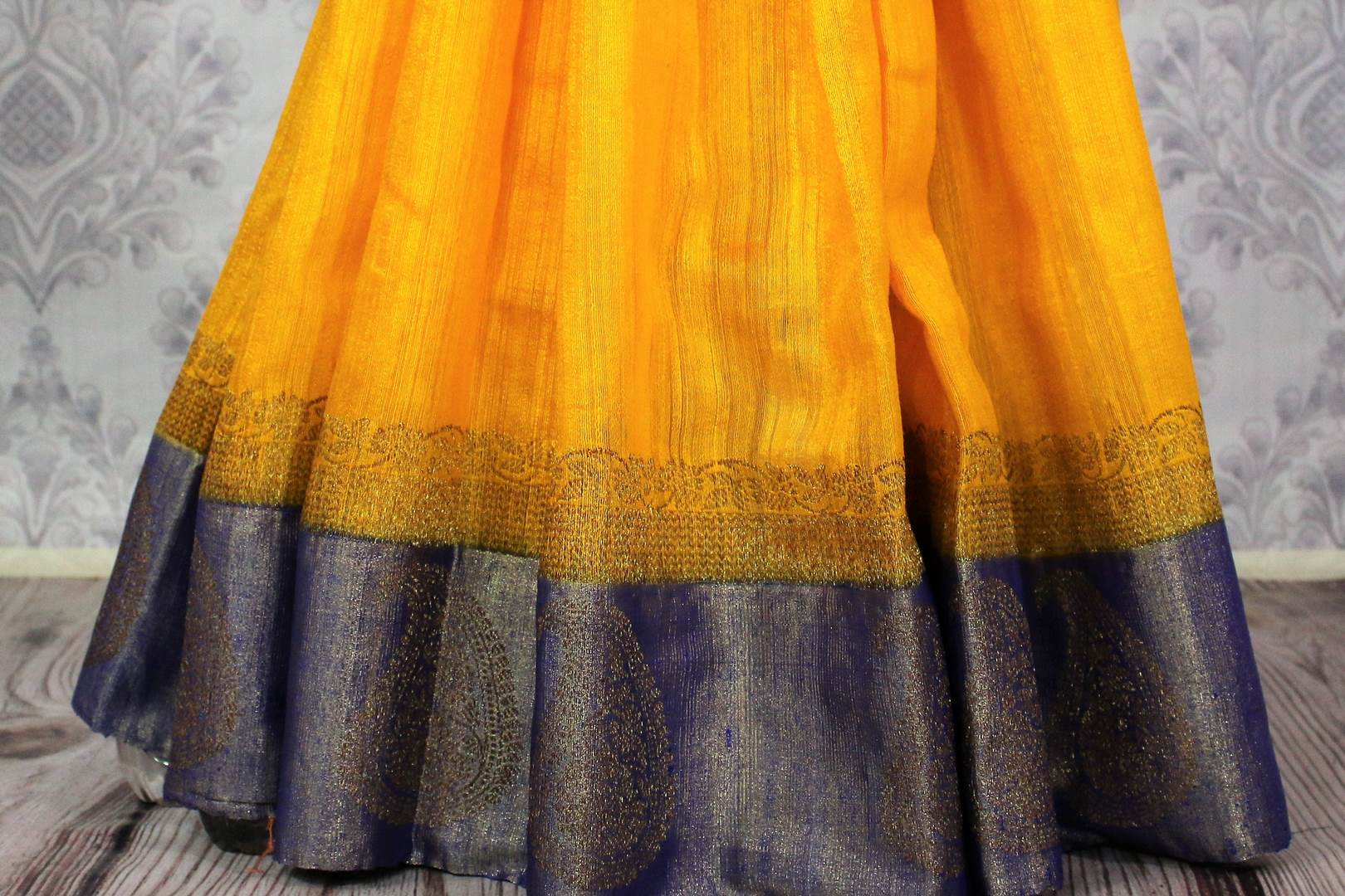 Shop yellow tussar Banarasi sari online in USA with blue border. Browse through a range of exclusive Indian handloom sarees in USA at Pure Elegance online store. -pleats